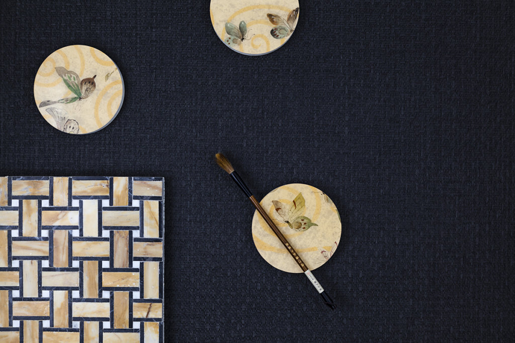 Dishes and brush on a natural texture wallcovering