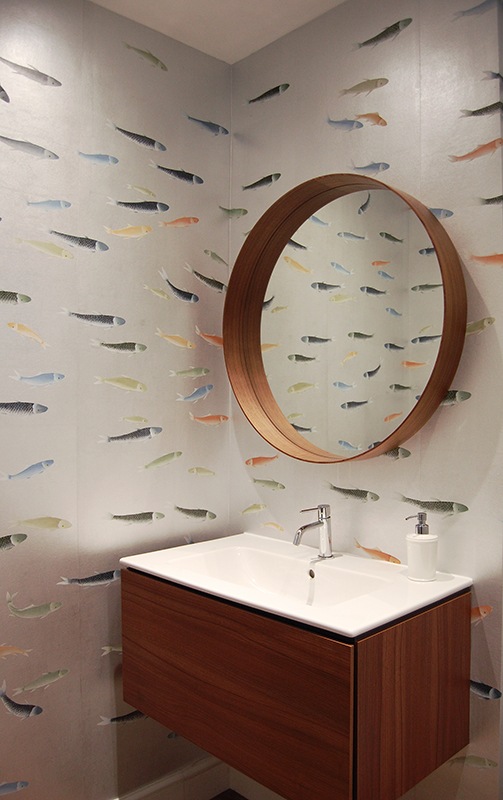 colourful fish on metallic wallpaper for powder room with big circular mirror